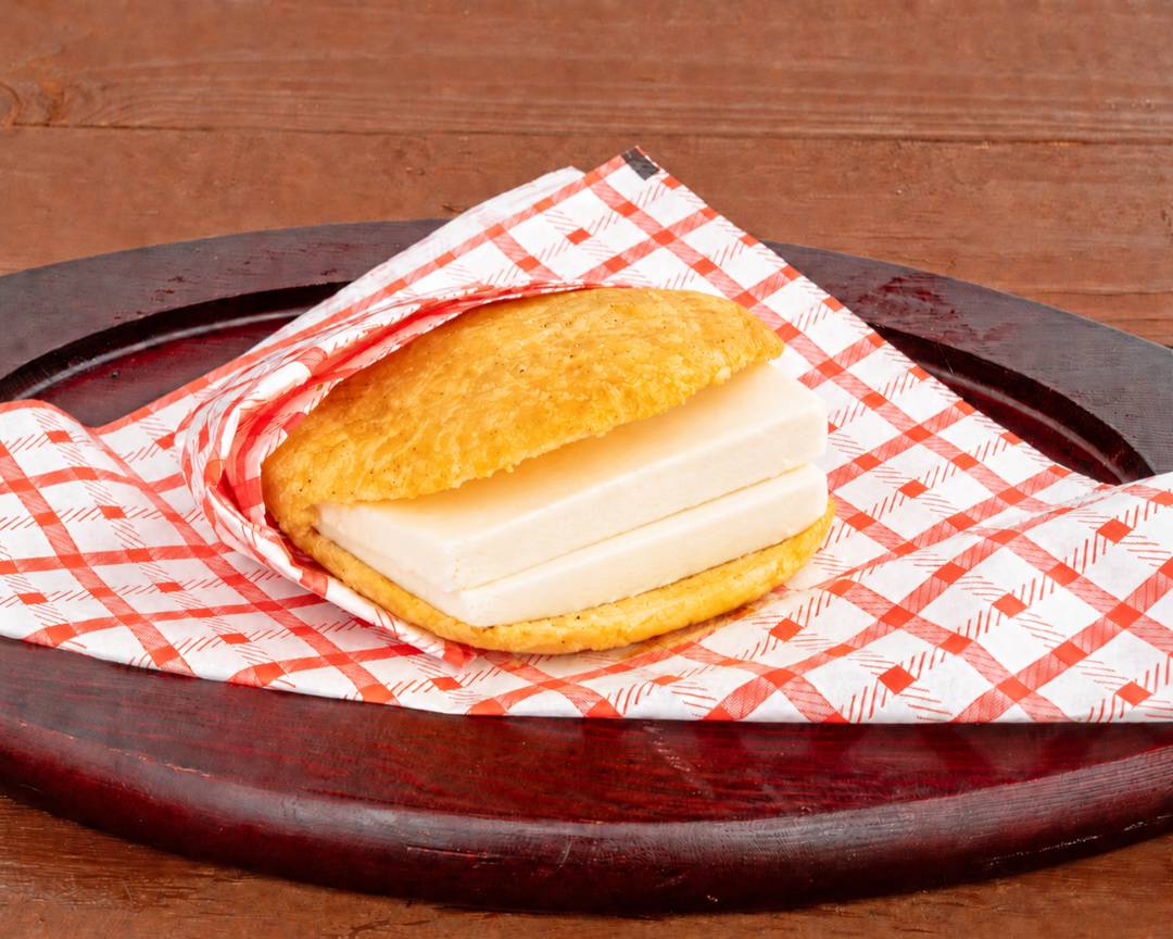 Arepa stuffed with thick slices of white cheese
