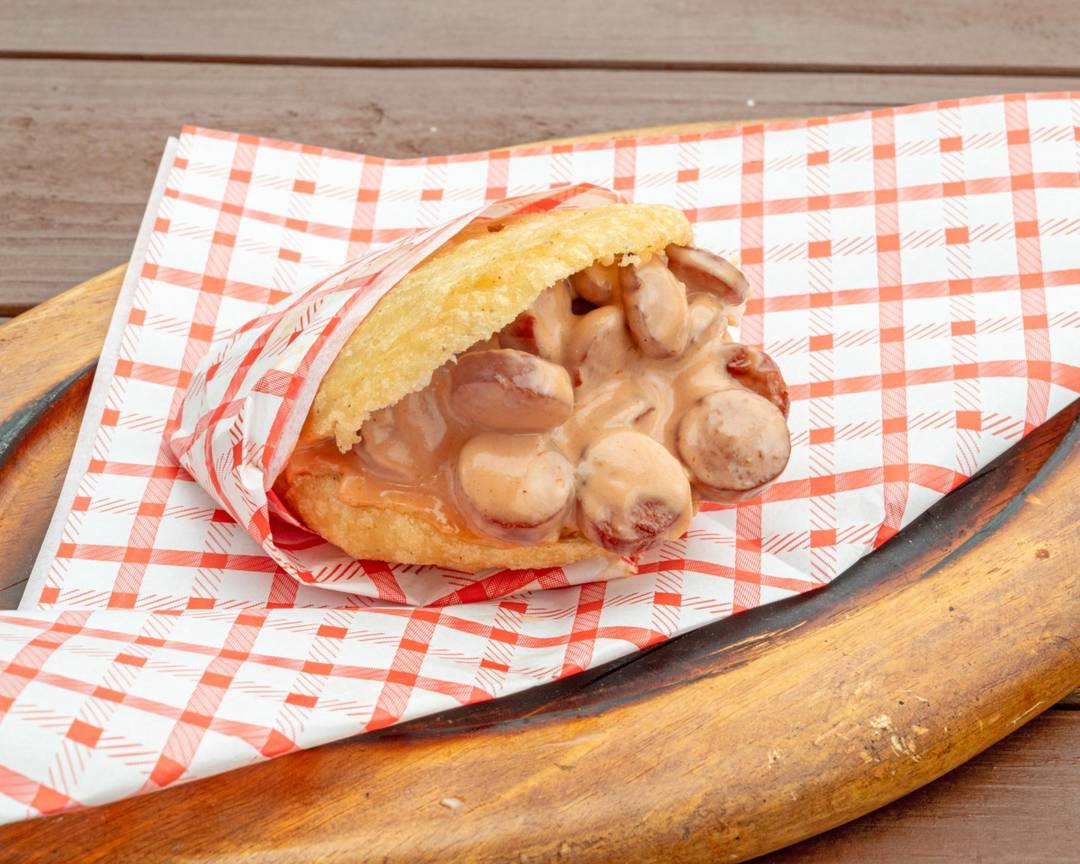 Arepa stuffed with sliced sausage