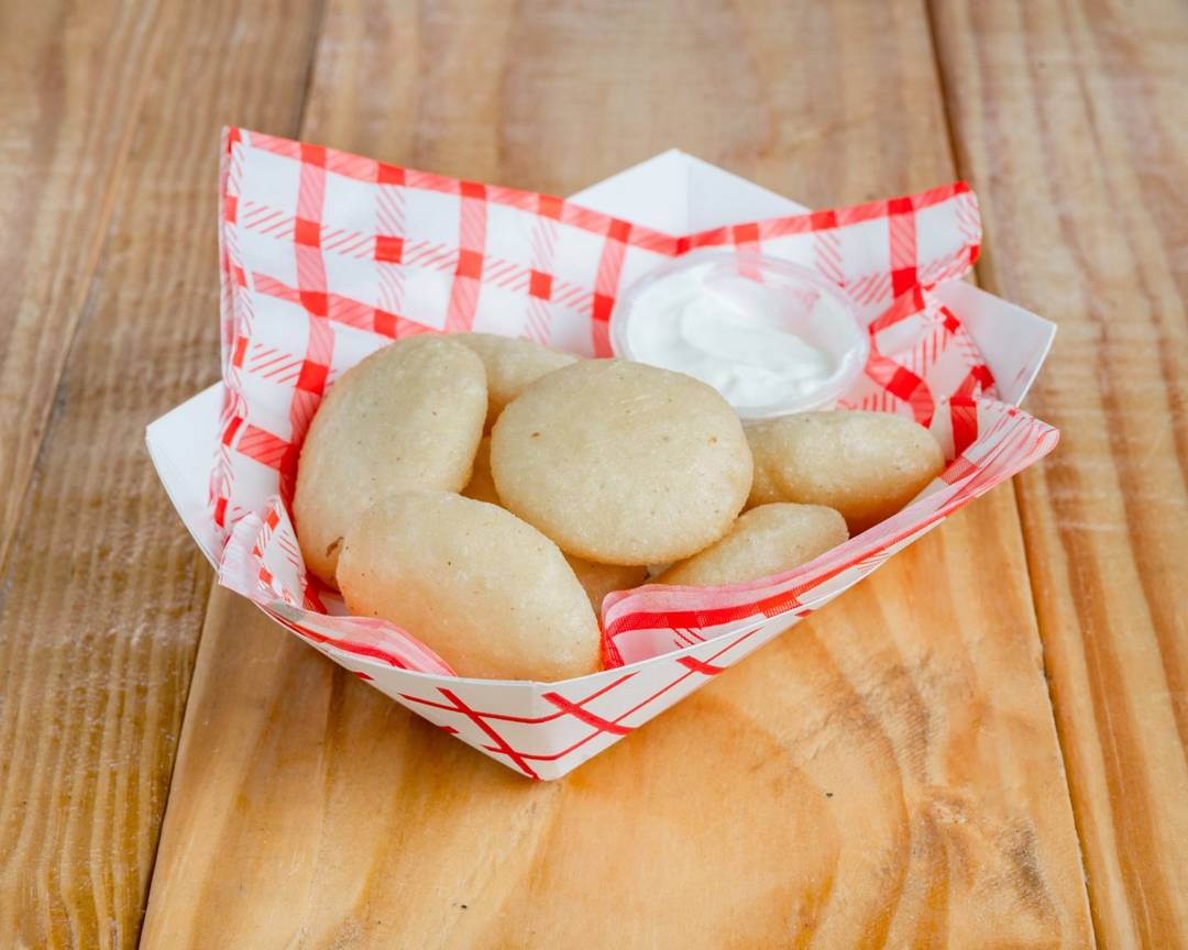 Fried mini arepitas with nata cream