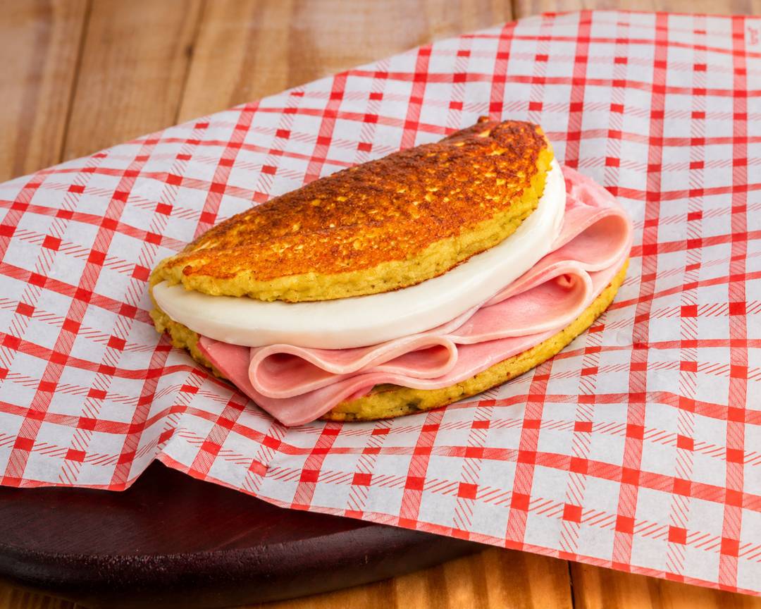 Cachapa with folded ham slices and queso de mano