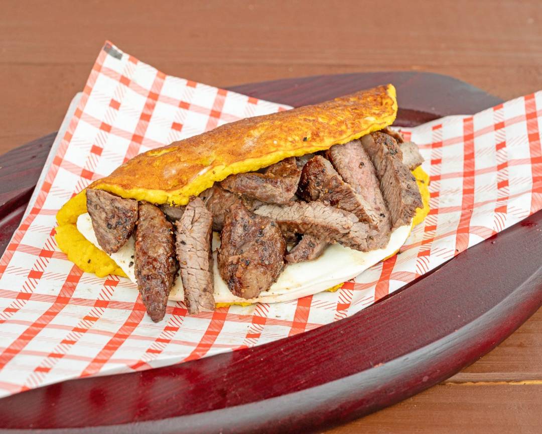 Cachapa picaña y queso: sweet corn pancake folded over grilled picaña steak and queso de mano