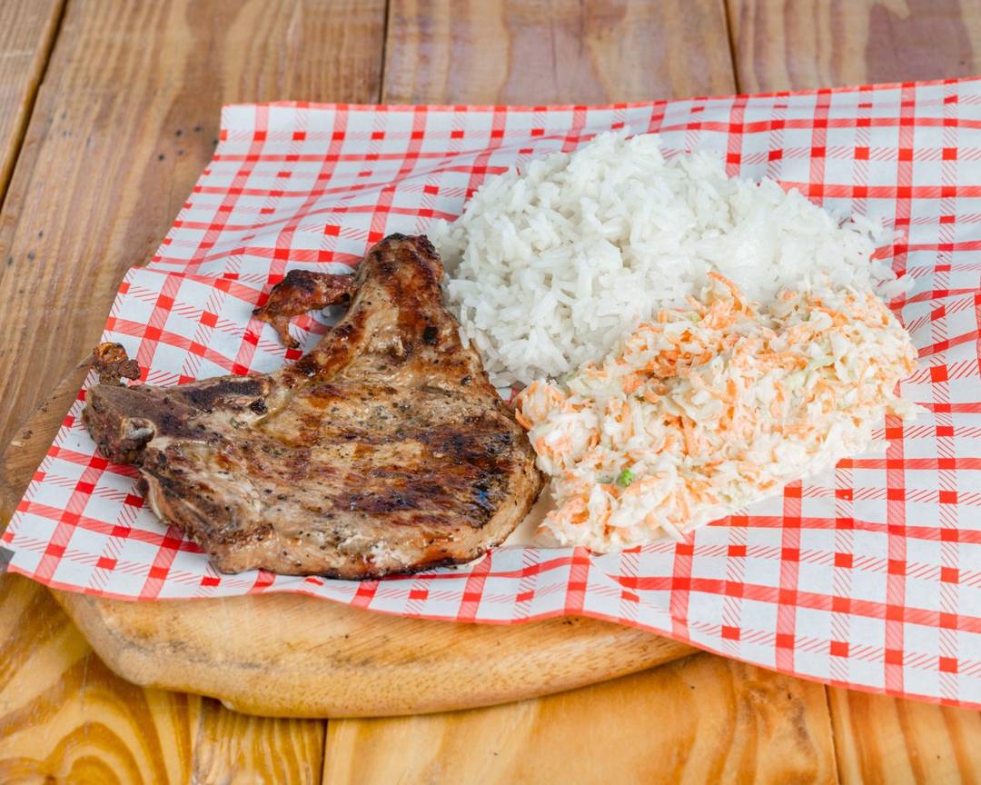 Smoked pork chop plate with white rice and coleslaw