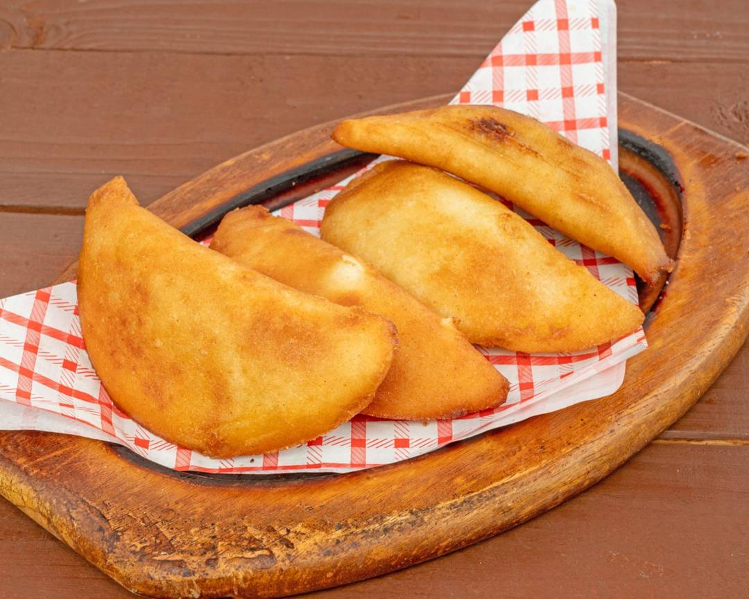 Golden fried Venezuelan empanadas with garlic dipping sauce