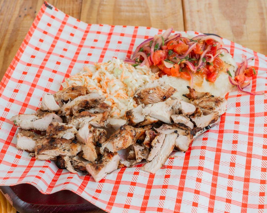 Grilled chicken parrilla plate with coleslaw, yuca and pico de gallo